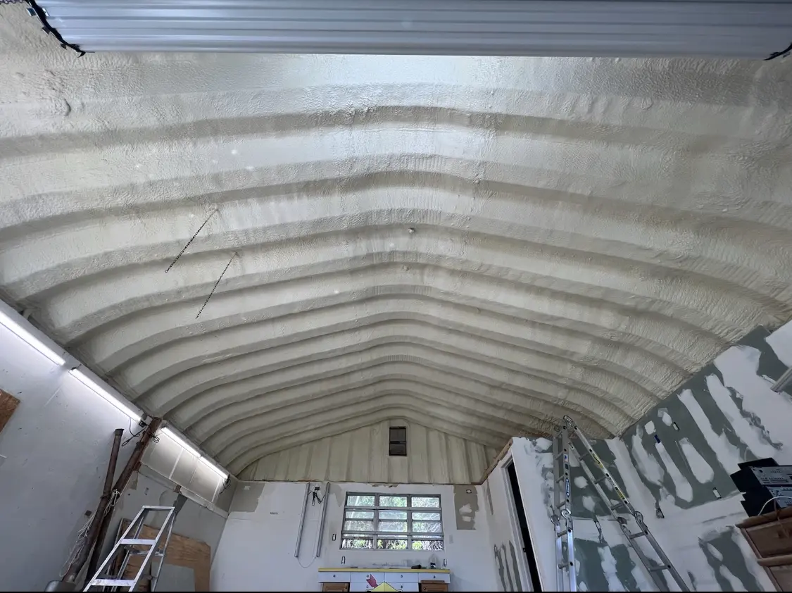 Spray polyurethane foam applied to the underside of a metal roof deck in Waldorf
